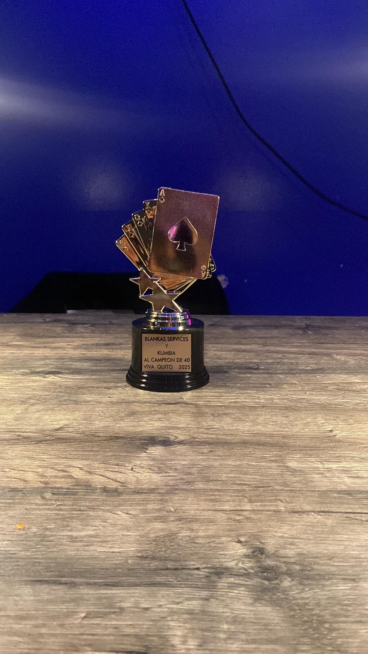 El trofeo del campeón de 40, con las cartas doradas y la placa grabada